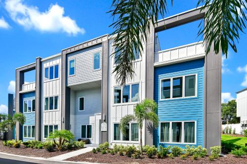 an apartment building with blue and white at Modern Condo with Large Outdoor Patio. Reunion Resort Water Park Access near Disney at Spectrum Resort Orlando by Rentyl - B30 #126 in Kissimmee