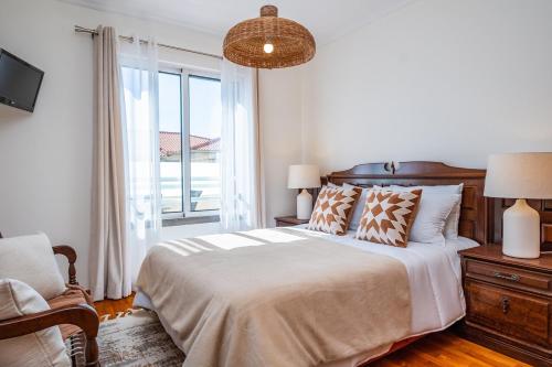 Een bed of bedden in een kamer bij Accommodation By Caniço VIP