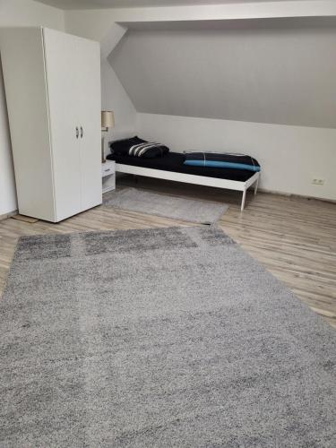 a bedroom with a bed and a rug at Fahrer- und Logistikservice in Hecklingen