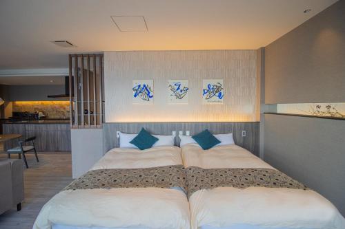 a bedroom with a large bed with two pillows at La-se-ri Resort & Stay - Vacation STAY 63385v in Himi