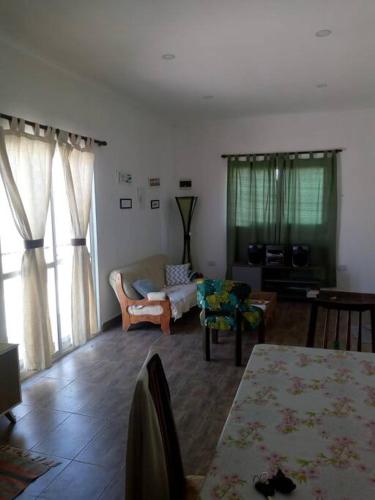 a living room with a couch and a table at Virgen de Lourdes in Goya