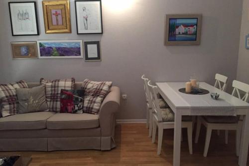 a living room with a couch and a table at Guesthouse Mala Luce Stobreč in Split