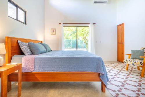 Un dormitorio con una cama grande y una ventana en Luxury 2 bedroom, walking distance to beach en Uvita