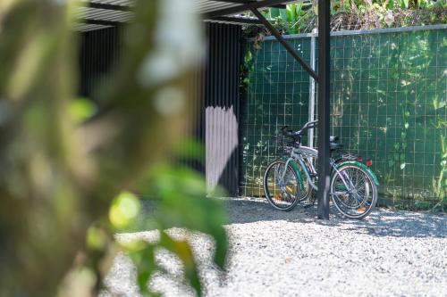 a bike parked next to a green wall at Luxury 2 bedroom, walking distance to beach in Uvita