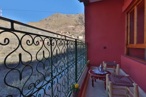 a balcony with a table and chairs and a window at La Perle de Neige in Imlil