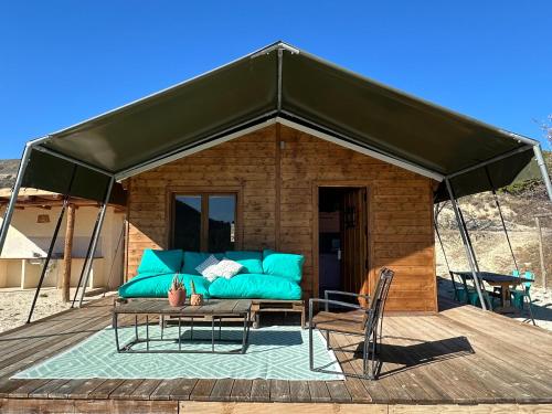 a tent with a couch and a table on a deck at Finca Les Coves in Jijona