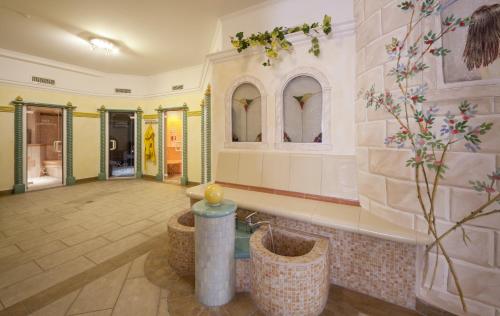 a lobby of a building with a room with mirrors at Raffl's Hotel in Leutasch