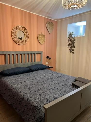 a bedroom with a bed and a mirror on the wall at Giuseppe & Greta in Bari
