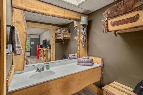 a bathroom with a sink and a mirror at Stonegate Lodge King Bed, WiFi, 50in TV, Fire Pit, Salt Water Pool Room # 310 in Eureka Springs