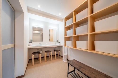 a bathroom with a sink and a counter with stools at Sakuraya Ryokan - Vacation STAY 51711v in Mongawa