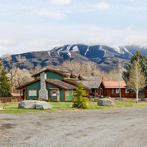 a house with a mountain in the background at 7 Point Ranch in Emigrant