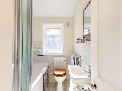 a bathroom with a toilet and a sink at 3 Bed in Swanage 84019 in Swanage