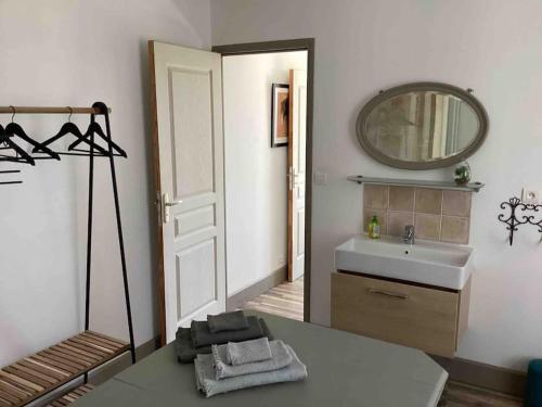 a bathroom with a sink and a mirror at Bellevue in Treignac