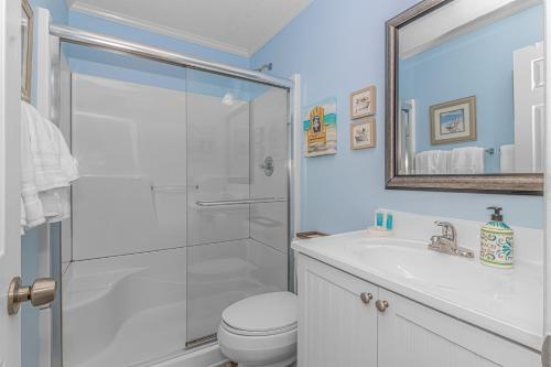 a bathroom with a shower and a toilet and a sink at Salty Dogs - Gated, Private Dock, Beach Access in Myrtle Beach