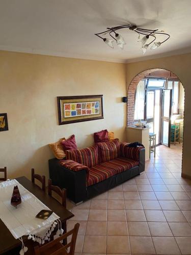 a living room with a couch and a table at Casa Vacanze Vanessa House in Ladispoli