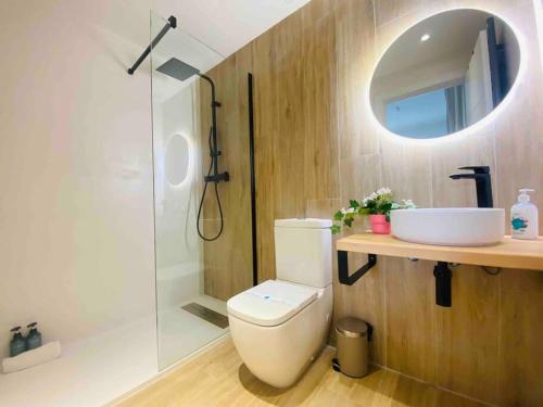a bathroom with a toilet and a sink and a shower at Nice & Cozy Flat Close The Beach in Valencia