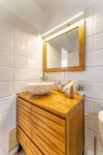 a bathroom with a sink and a mirror at mggb05 in Grand-Bourg