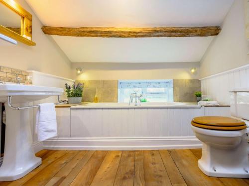 a bathroom with a toilet and a bath tub at 2 Bed in Ullswater 87349 in Penrith