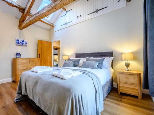 a bedroom with a large bed and a wooden floor at 2 Bed in Ullswater 87349 in Penrith