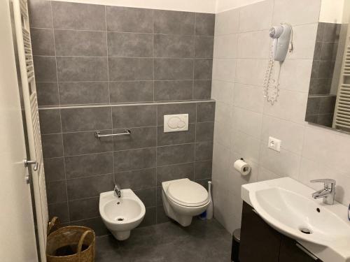 a bathroom with a toilet and a sink at Villa Mazzano in Riva del Garda