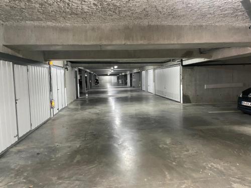 an empty parking garage with a car parked in it at Caprozion-Erosoa-T1-Piscine-Clim in Ciboure