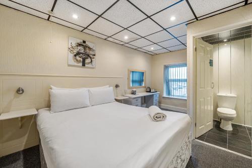 1 dormitorio con 1 cama grande y baño en Bluewaters Hotel Blackpool, en Blackpool