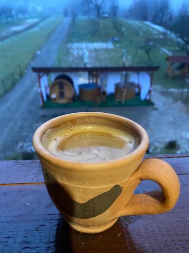 a cup of coffee sitting on top of a table at Pensiunea Codrea - Wagner in Lazu Baciului