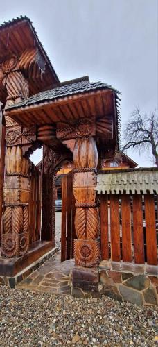 a building with logs stacked on top of it at Pensiunea Codrea - Wagner in Lazu Baciului