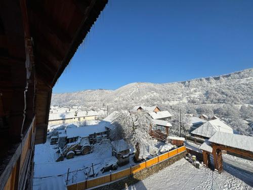 a view of a snow covered mountain from a building at Pensiunea Codrea - Wagner in Lazu Baciului