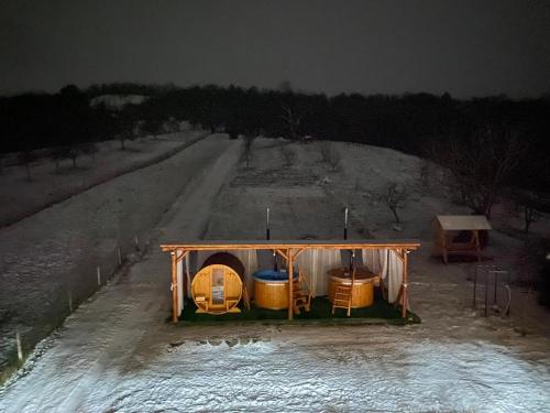a tent on the side of a dirt road at night at Pensiunea Codrea - Wagner in Lazu Baciului