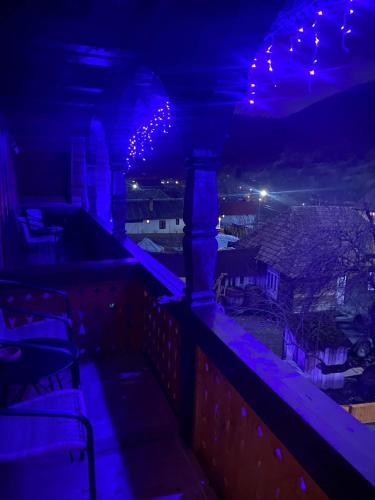 a view of a city at night with purple lights at Pensiunea Codrea - Wagner in Lazu Baciului