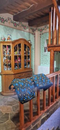 a table and two chairs in a room with a cabinet at Pensiunea Codrea - Wagner in Lazu Baciului