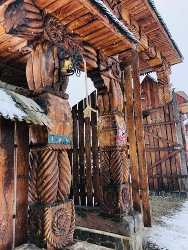 a wooden building with lots of wooden logs at Pensiunea Codrea - Wagner in Lazu Baciului