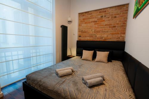 a bedroom with a bed with two pillows on it at Luna Apartment in Krakow