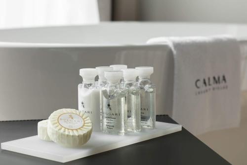 a shelf with four bottles of soap and a cupcake at 5-Star Villa Calma II with Heated Pool & Jacuzzi Oasis in Starigrad-Paklenica