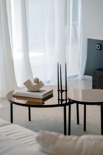 a coffee table with a hat and books on it at 5-Star Villa Calma II with Heated Pool & Jacuzzi Oasis in Starigrad-Paklenica