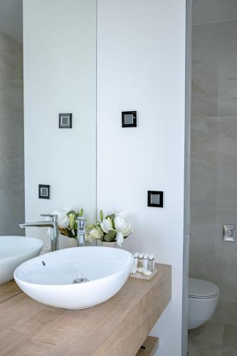 a bathroom with a large white sink and a mirror at 5-Star Villa Calma II with Heated Pool & Jacuzzi Oasis in Starigrad-Paklenica