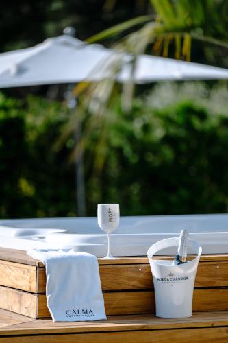 a table with a towel and a cup of coffee at 5-Star Villa Calma II with Heated Pool & Jacuzzi Oasis in Starigrad-Paklenica
