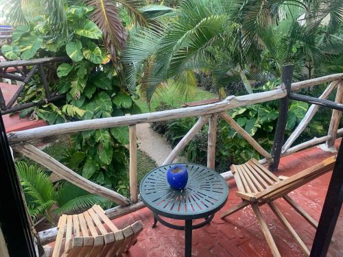 a table and chairs on a patio with palm trees at Casa CARIBE Cancun in Cancún