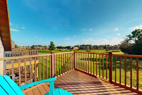 a deck with chairs and a view of a golf course at Tigers Den - Upper in Arkdale