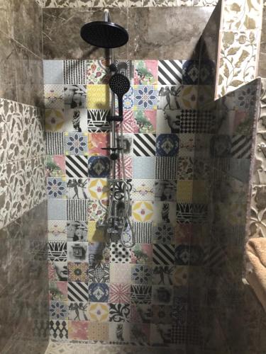 a quilt hanging on a wall in a bathroom at New Villa Carimo in Quseir