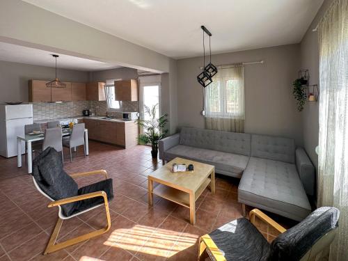 a living room with a couch and a table at MyseA VillasNikiti in Nikiti