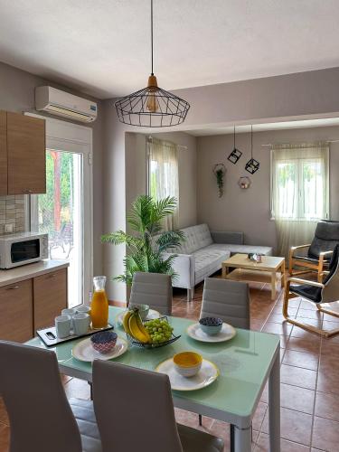 a kitchen and living room with a table with fruit on it at MyseA VillasNikiti in Nikiti