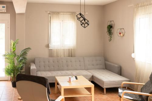 a living room with a couch and a table at MyseA VillasNikiti in Nikiti