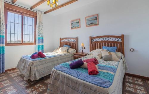 a bedroom with two beds with pillows on them at Casa Rural Pío in Montilla