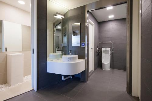 a bathroom with a sink and a toilet at Uljiro Coop Residence Dongdaemun in Seoul