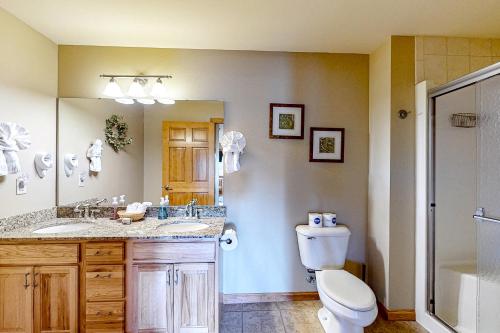 a bathroom with a toilet and a sink at Tigers Den - Lower in Arkdale
