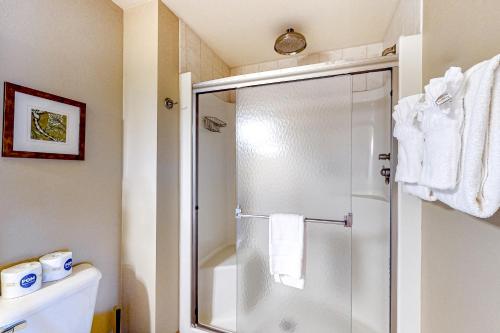 a bathroom with a shower with a glass door at Tigers Den - Lower in Arkdale