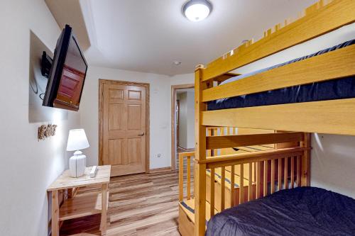a bedroom with a bunk bed and a desk at Tigers Den - Lower in Arkdale