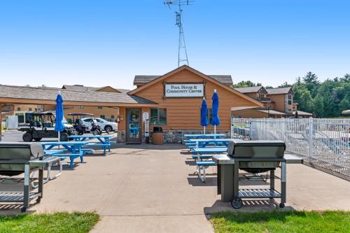 a group of blue picnic tables in front of a building at Tigers Den - Lower in Arkdale